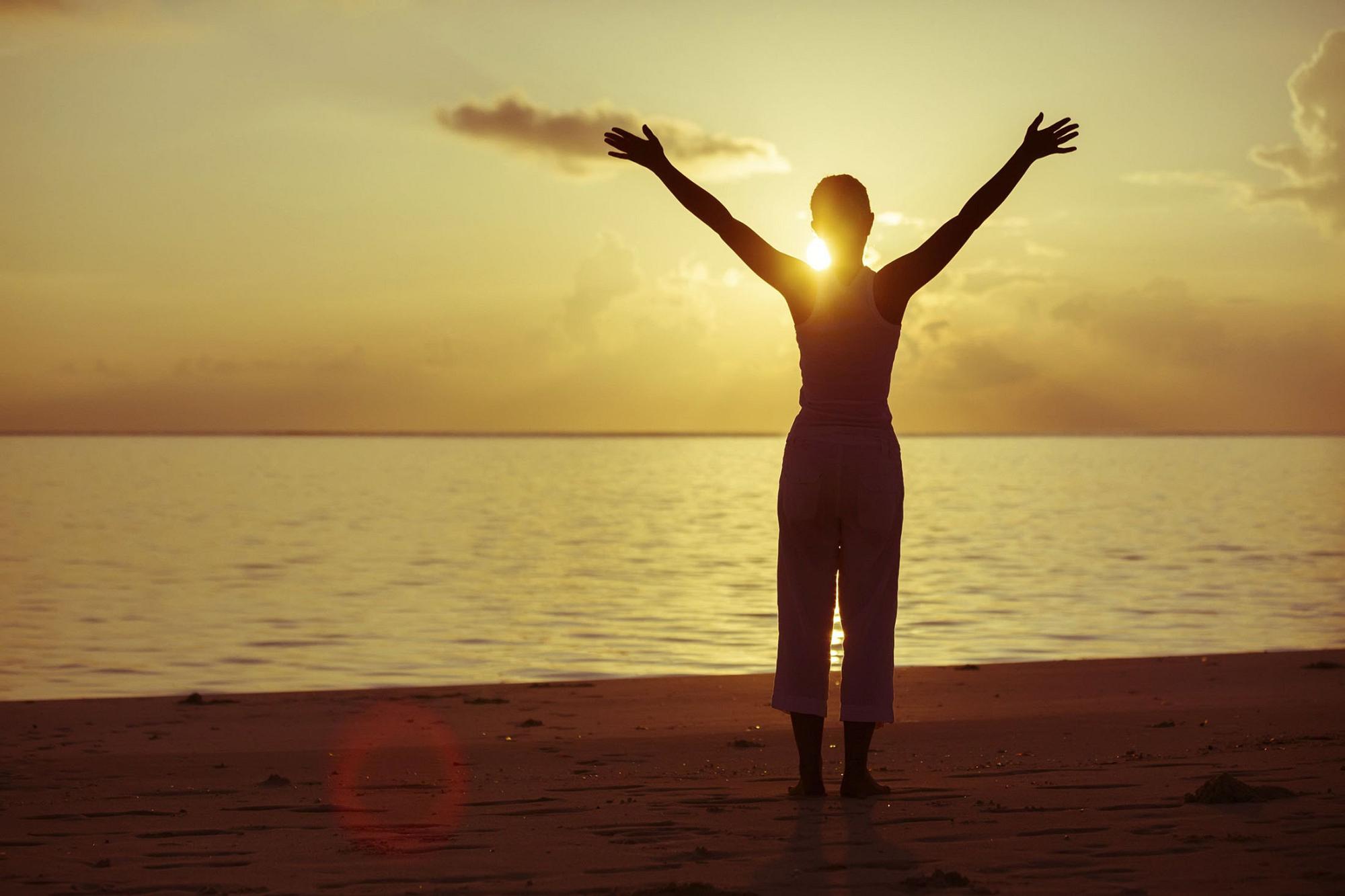 The silhouette of a woman against the sunset