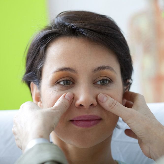 Examining a woman's nose