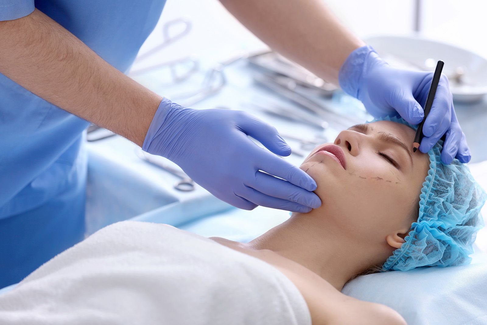 A woman being marked up by a plastic surgeon just prior to her surgery